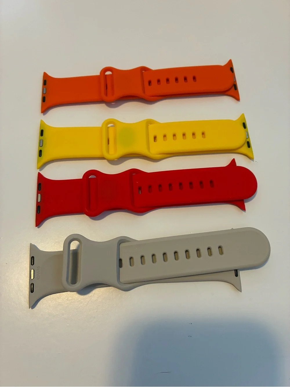 4 pack of Silicon Apple Watch bands. 42mm Red/Yellow/Orange/Tan only